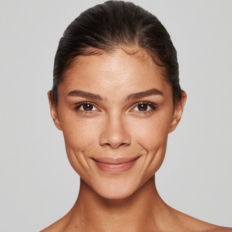 Face with AI landmark overlay showing symmetry and proportion analysis